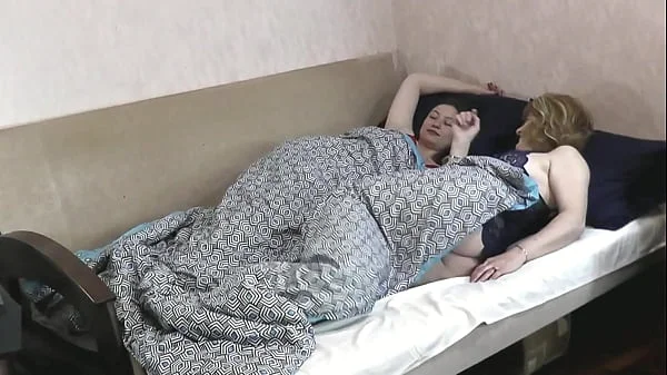 Two women. Lesbians. Bisexual. Adult mature sexy blonde MILF and cute brunette girl in one bed in bedroom in morning kiss get dressed and go to work, university. Big natural tits Ass Pussy. Striptease