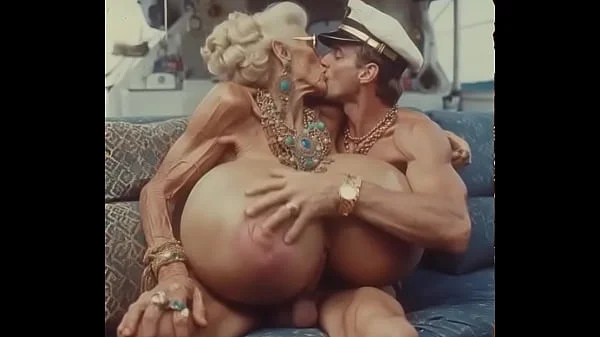 JAY7 Granny Boob Cruise 01 - AI VIDEO - A topless and horny granny with huge bolt-on tits gives a crazy titjob to the skipper
