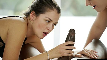 Two hot babes are getting fucked in the kitchen by a guy.